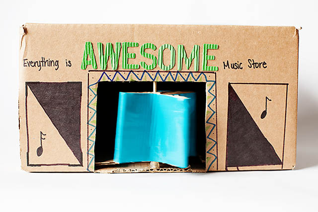 DIY cardboard building with revolving door - from All for the Boys blog