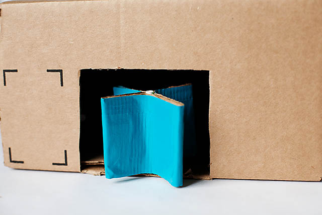 DIY cardboard building with revolving door - from All for the Boys blog