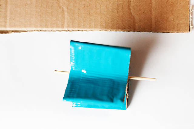 DIY cardboard building with revolving door - from All for the Boys blog