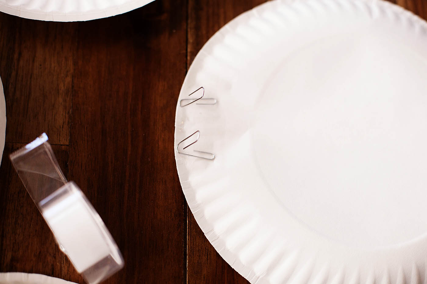 Paper plate targets and rubber band bracelet bow and arrow