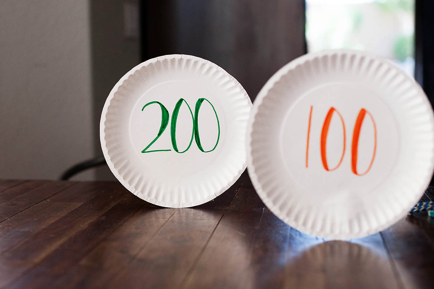 Paper plate targets and rubber band bracelet bow and arrow