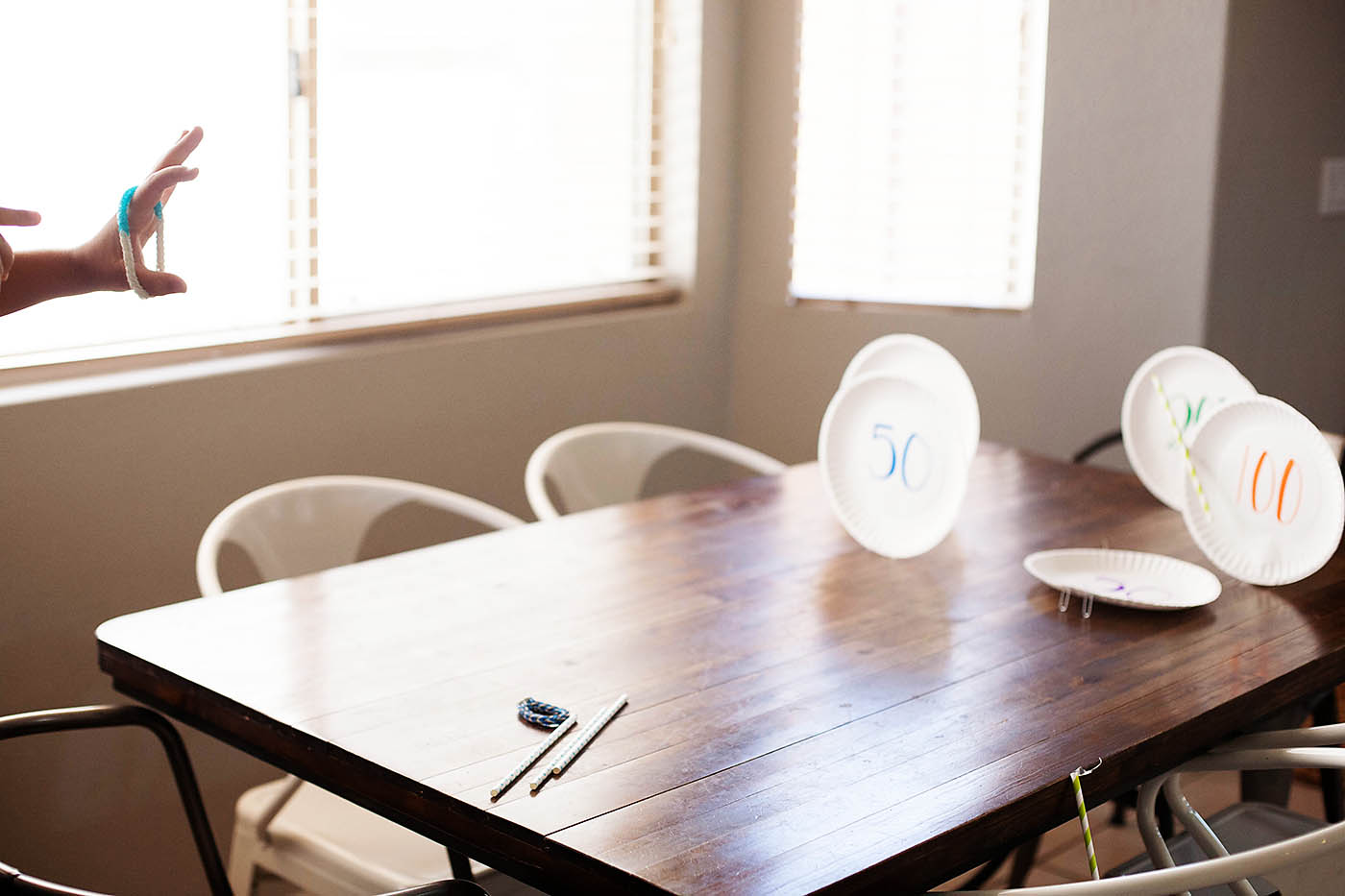 Paper plate targets and rubber band bracelet bow and arrow