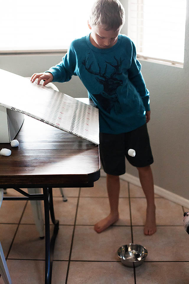 Snowball roll game using cotton balls from All for the Boys blog