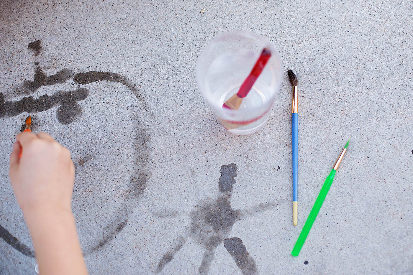 Paint with water - a super simple summer activity to keep kids busy  and you likely have everything you need already!