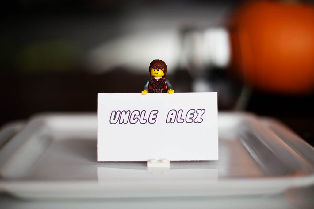 LEGO minifigure holding a name card on a dinner plate